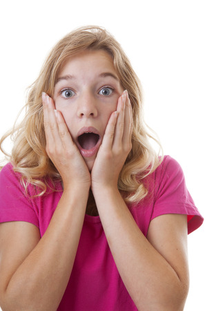 Portrait of girl who looks surprised over white backgroundの写真素材