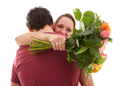 Girl is happy with bouquet of flowers giving by boyfriend over white backgroundの写真素材