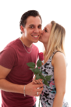 Girl is happy with rose giving by boyfriend over white backgroundの写真素材