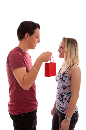 Man is giving present to his girlfriend isolated on white backgroundの写真素材