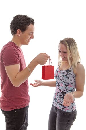 Man is giving present to his girlfriend isolated on white backgroundの写真素材