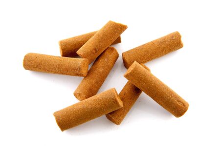 Bunch of cinnamon sticks over white backgroundの写真素材