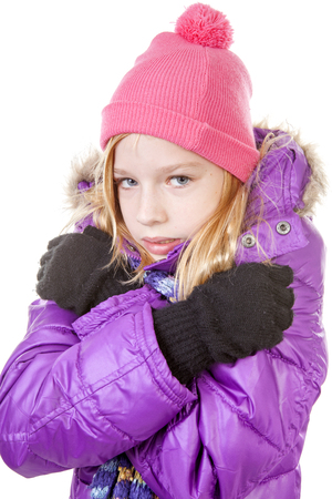 young girl in winter outfit heaving cold over white backgroundの写真素材