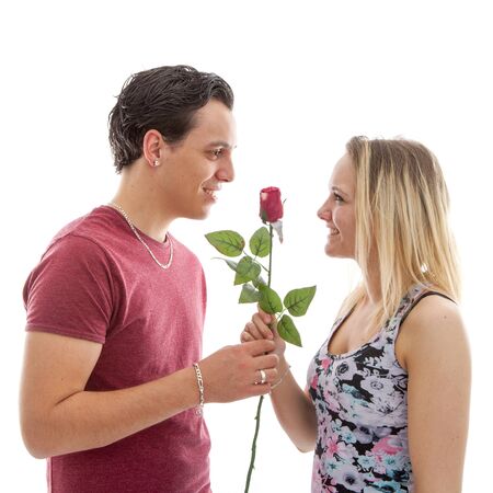 Girl is happy with rose giving by boyfriend over white backgroundの写真素材