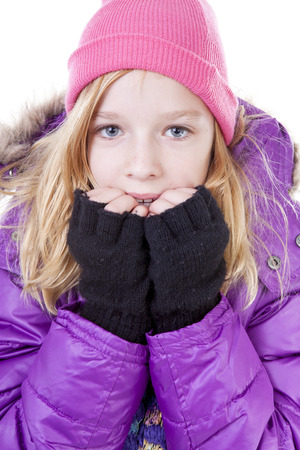Teenage girl is posing in winter outfit over white backgroungの写真素材