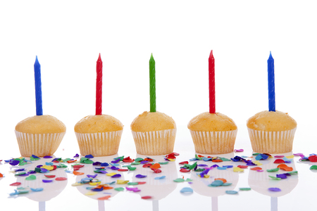 Birthday cupcakes in a row over white backgroundの写真素材