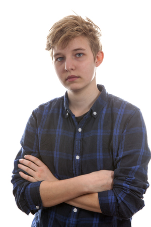 Teenage transgender boy is looking angry. Posing over white backgroundの写真素材