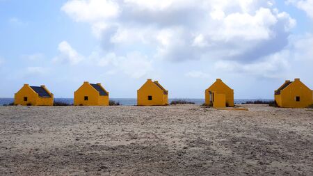 Yellow slave houses on the beach of Bonaireの写真素材