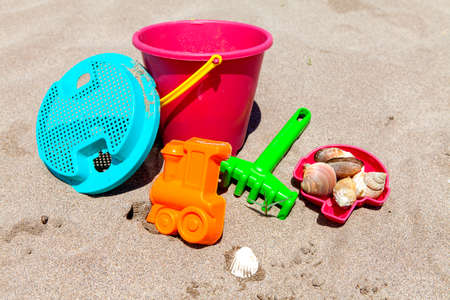 Toys for little kids on the beach on sunny dayの写真素材