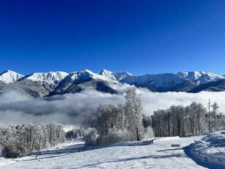 snow and clouds over mountainsの写真素材