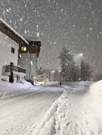 snow-covered house and streetの写真素材
