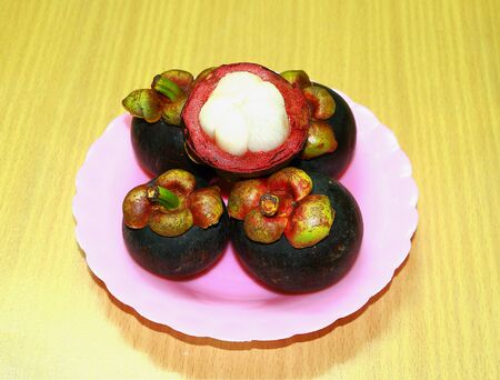 Mangosteen in dish on background.の写真素材