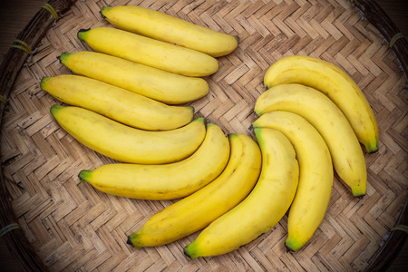 Ripe bananas on a bamboo trayの写真素材