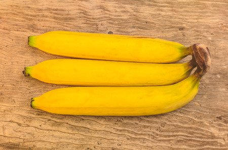 Ripe bananas on woodの写真素材