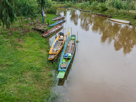 wood rowboat on canal in Thailand stock photoの写真素材