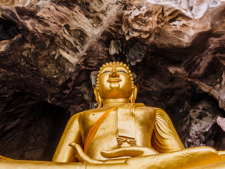 golden buddhist  in wild cave at Wat Tham Erawanの写真素材
