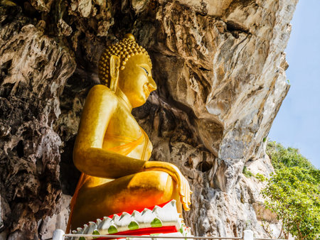 golden buddhist  in wild cave at Wat Tham Erawanの写真素材