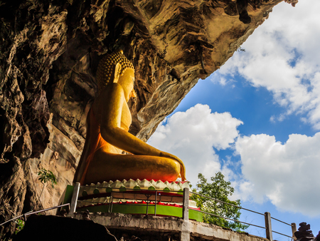golden buddhist  in wild cave at Wat Tham Erawanの写真素材