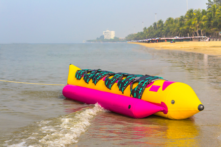 banana boat lays on a beach in blue skyの写真素材