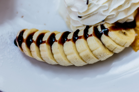 Banana slices topped with chocolate.の写真素材