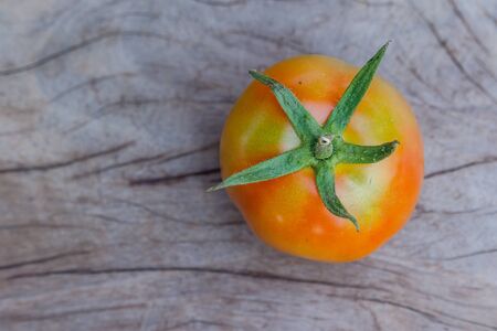top view of red tomatoes on wooden tableの写真素材