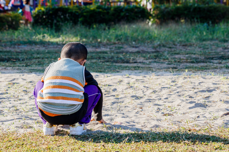 Rear view of a boy playing the sand. Playgroundの写真素材