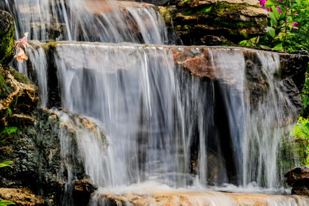 Rocks with artificial waterfall on the territory of hotel at resortの写真素材