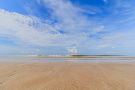 Sea sand sky and soft wave of blue ocean on sandy beach summer dayの写真素材