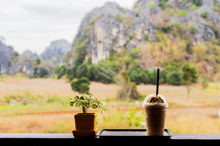 Cold coffee amid nature and mountainsの写真素材