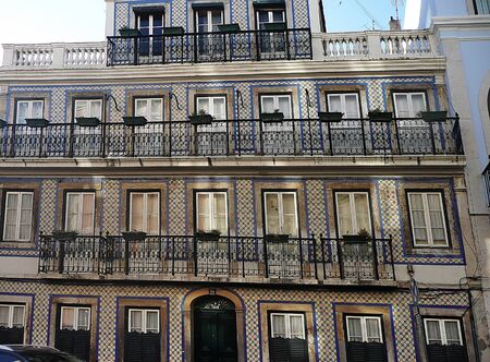Typical palace in a street of the center of Lisbon with flag, Portugalの写真素材