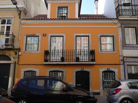 Typical palace in a street of the center of Lisbon with flag, Portugalの写真素材