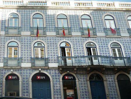 Typical palace in a street of the center of Lisbon with flag, Portugalの写真素材