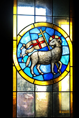Stained glass window in the cathedral of Florence with the emblem of the Wool Guild, Italyのeditorial素材