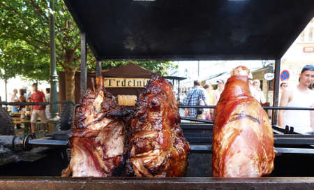 Ham cooking on a wood stove in the street of Prague.のeditorial素材