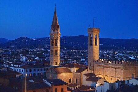 Bell tower of the Badia Fiorentina and Bargello Palace at night Florence Italyの写真素材