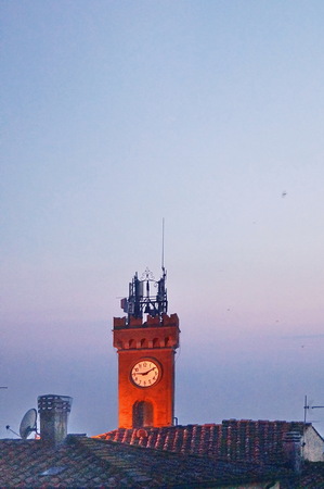 Clock Tower at sunset of the village of Castagneto Carducci, Tuscany, Italyの写真素材