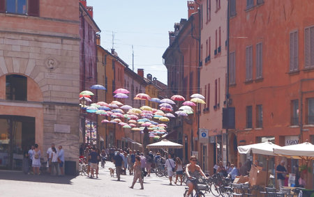 Giuseppe Mazzini street with hanging umbrellas, Ferrara, Italy
