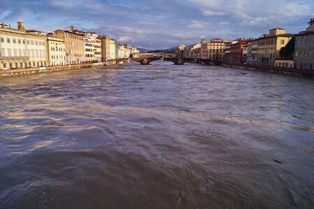 The swollen river Arno in Florence, Italyの写真素材