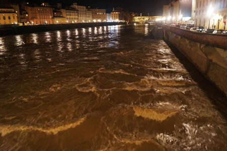 The river Arno in full at night in Florence, Italyの写真素材