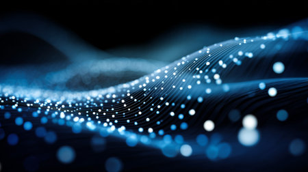 A stunning abstract representation of a flowing wave of light particles in blue and white hues, symbolizing digital connectivity and modern technology.の素材
