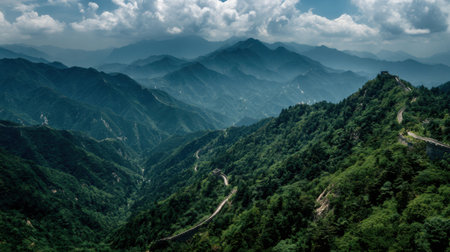 Explore a breathtaking mountain landscape featuring lush greenery and gentle fog enveloping peaks under a vast sky. Experience calm nature.の素材