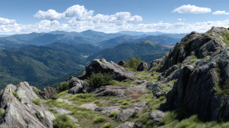 Experience the stunning beauty of a mountain landscape featuring rocky terrain, lush greenery, and a breathtaking sky. Perfect for travel-themed projects.の素材