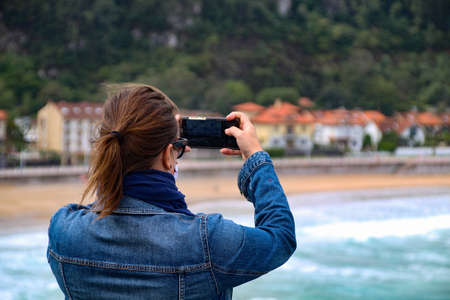 Girl holding mobile with handの写真素材