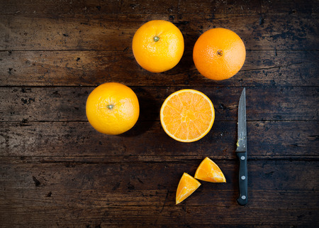 Oranges isolated cut set on wooden baseの写真素材