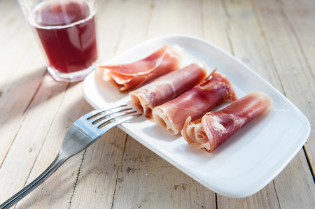 plate of cured ham on wooden backgroundの写真素材