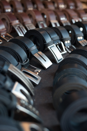 leather belts of different colors and with metal bucklesの写真素材