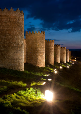 walls of Avila on dusk sky background