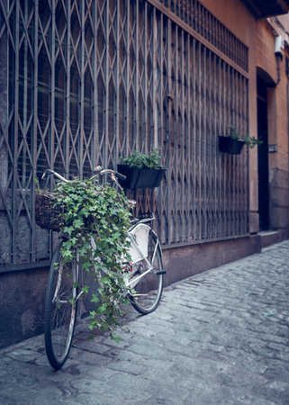 Old bike resting on the wall in retro styleの写真素材