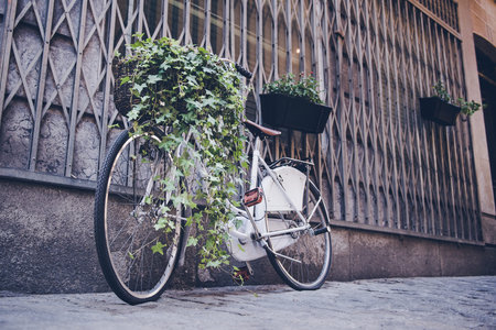 Old bike resting on the wall in retro styleの写真素材