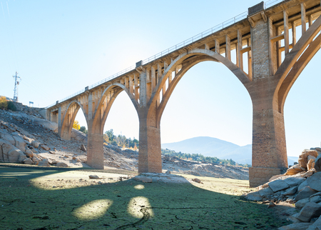 Arid terrain as a result of the drought with old and new bridge background in constructionの写真素材
